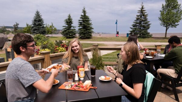 St. Scholastica students eating together in Canal Park.